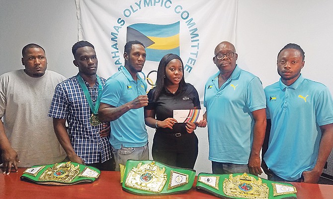 Coach Keishno Major, boxers Lennox Boyce and Carl Hield, Jayme Pinder of Alive, boxing federation president Wellington Strachan and boxer Ronald Woodside.