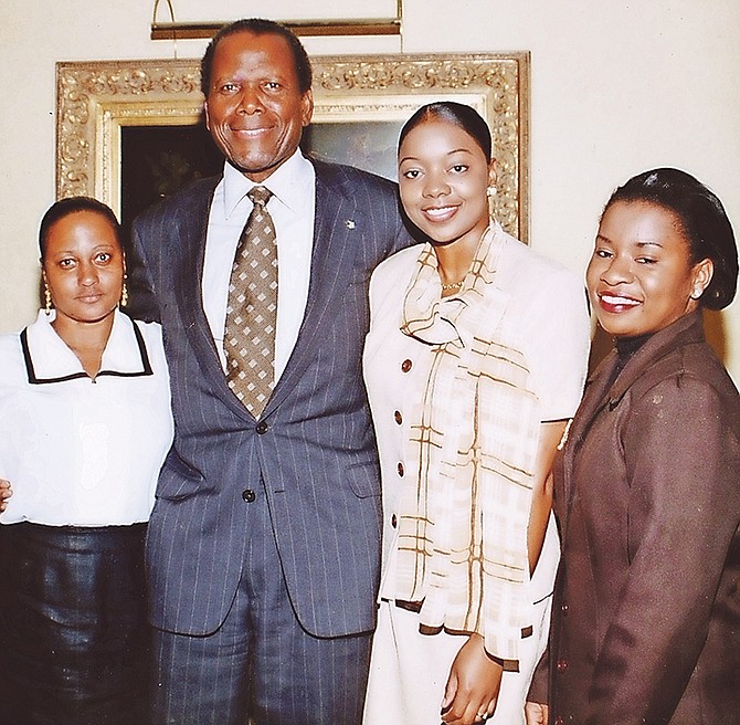 Sir Sidney pictured during a visit to Grand Bahama in the 1990s. Tribune reporter Denise Maycock stands next to him, on his left.