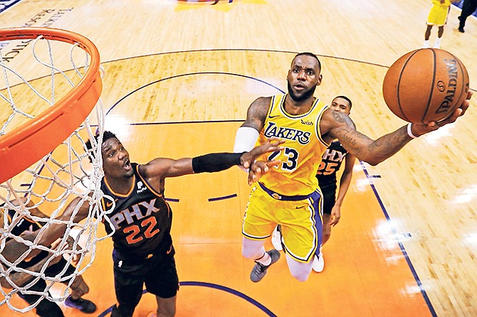 Los Angeles Lakers forward LeBron James (23) drives past Phoenix Suns centre Deandre Ayton during the second half on Saturday in Phoenix. The Suns beat the Lakers 118-109.

(AP Photo/Rick Scuteri)