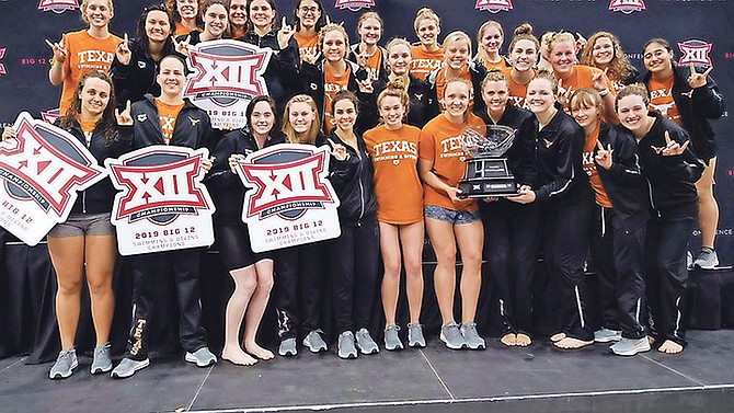 Joanna Evans, second from left in front row, with the second-ranked University of Texas women’s swimming and diving team after winning their seventh-straight Big 12 title on Saturday night.