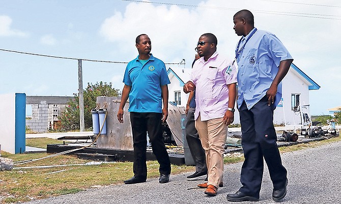 Adrian Gibson, centre, WSC chairman and MP for Long Island, inspects the facilities on Ragged Island last week.