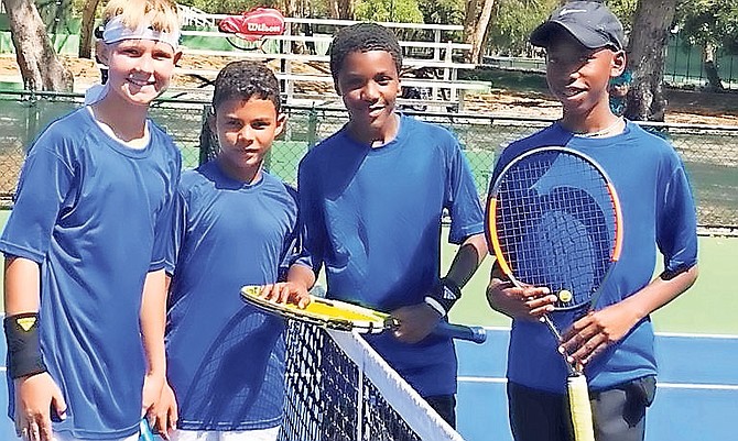 Top Bahamian junior tennis players Dentry Mortimer Jr (3rd from left) and Anthony Burrows Jr (far right) with their doubles opponents from Aruba.