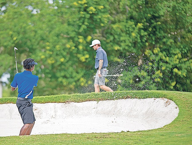 UB golf team member John Hall chips his ball out of the bunker.