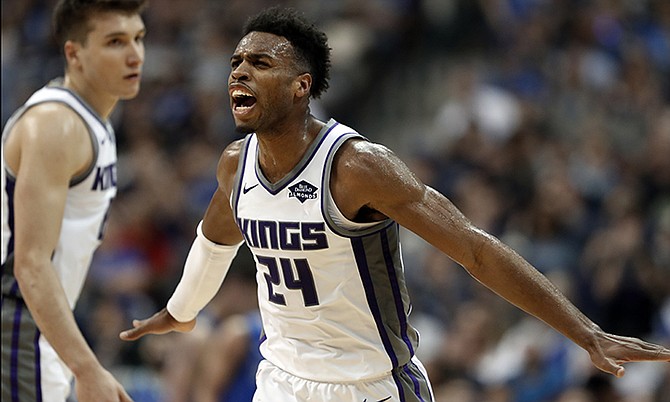 Sacramento Kings guard Buddy Hield (24) celebrates with Bogdan Bogdanovic, left, after sinking a three-point basket in the second half of an NBA basketball game against the Dallas Mavericks in Dallas, Tuesday, March 26, 2019. (AP Photo/Tony Gutierrez)