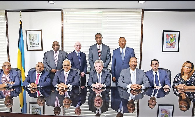 Minister of Tourism Dionisio D’Aguilar, seated third left, along with Minister of State for Grand Bahama, Senator Kwasi Thompson, seated second left, was joined by Michael Scott, seated centre, chairman of Lucayan Renewal Holdings Ltd; Russell Benford, seated, third right, vice-president of Government Relations/Americas for Royal Caribbean; Mauricio Hamui, seated second right, chief executive officer of ITM, along with Board Members of Lucayan Renewal Holdings, standing, for LOI signing for the purchase of the Grand Lucayan resort, in the Office of the Prime Minister yesterday. Photo: Lisa Davis/BIS
