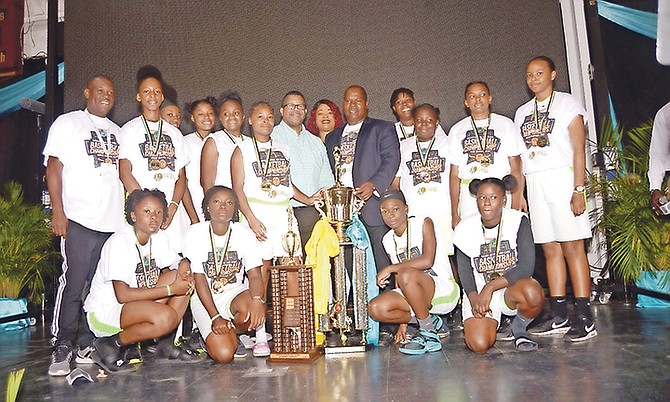 Deputy Prime Minister Peter Turnquest presents head coach Oswaldo Taylor and his St John's Giants the senior girls winning trophy.