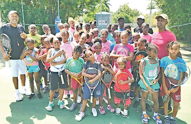 The children who participated in the tournament with, from left, coach Cory Francis, Shayvon Clarke, Bernard Clarke, Perry Newton and coach Mike Butler.