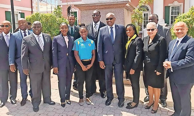Fed Cup players Sydney Clarke and Danielle Gibson are flanked by Prime Minister Hubert Minnis and other Members of Parliament.