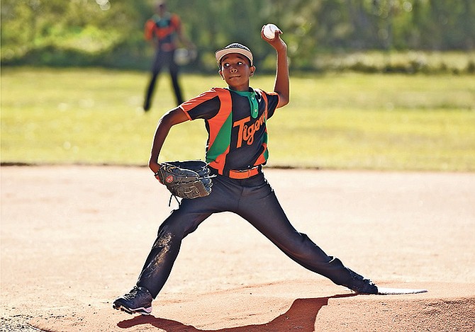 Tavano Baker, of the AF Adderley Fighting Tigers, in action yesterday as the Government Secondary Schools Sports Association’s softball (for girls) and baseball (for boys) season got underway at Baillou Hills Sporting Complex.

Photos: Shawn Hanna/Tribune Staff