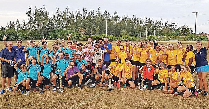 Lyford Cay International School’s three soccer teams celebrate their BAISS championships.