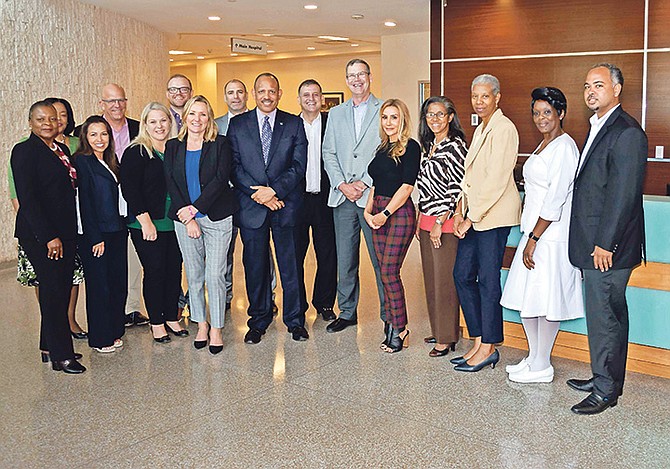 Minister of Health Dr Duane Sands with Disney executives at Princess Margaret Hospital yesterday.