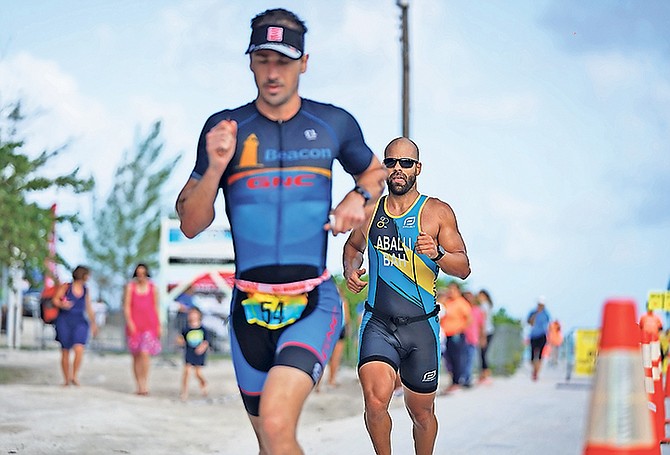 JASON Costelloe leads the way with Bahamian national champion Jorge Marcos close behind Sunday morning. Costelloe pulled away from Marcos to take the title in the newly implemented Olympic Triathlon, comprising of a 1,500 metre swim, 26-mile bike and 6-mile run.

Photo by Terrel W Carey Sr/Tribune Staff