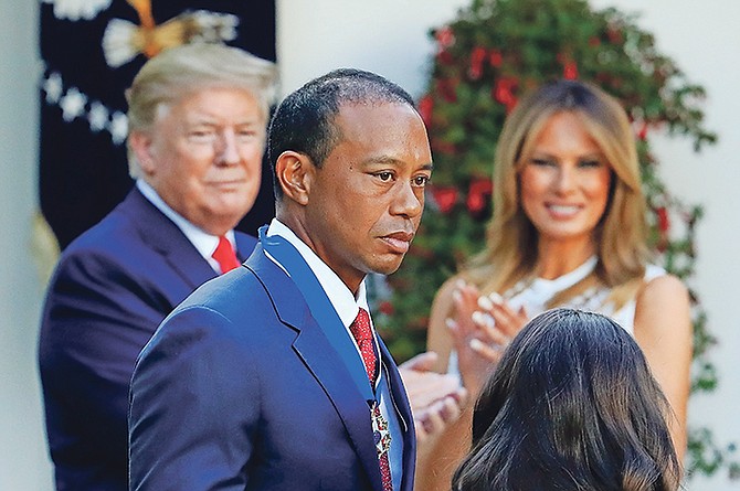 President Donald Trump and first lady Melania Trump applaud Tiger Woods during a ceremony awarding the Presidential Medal of Freedom to the golfer at the White House on Monday.