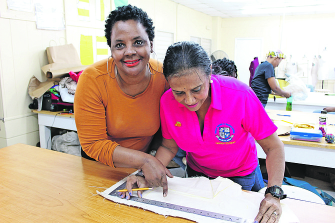 Chair of BTVI’s Fashion programme, Kathy Pinder, take a moment to smile for the camera while helping a student.