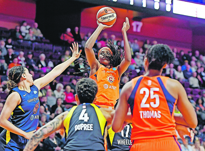 Connecticut Sun centre Jonquel Jones shoots over the Indiana Fever defence on Tuesday night.

(Sean D Elliot/The Day via AP)