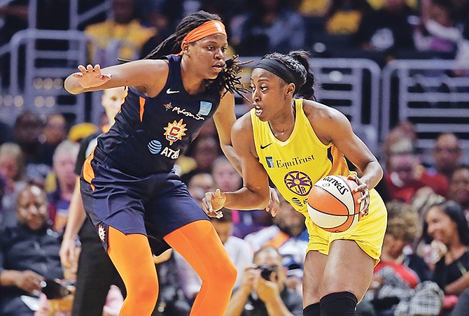 Los Angeles Sparks’ Chiney Ogwumike, right, is defended by Connecticut Sun’s Jonquel Jones during the first half of Friday’s game in Los Angeles.

(AP Photo/Marcio Jose Sanchez)