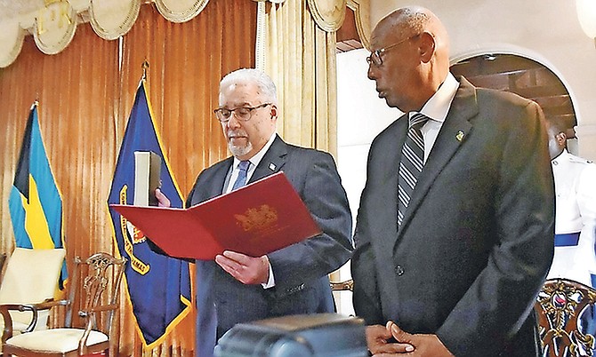 Brian Moree, QC, is sworn in as Chief Justice at Government House. Looking on is Cornelius A Smith, Deputy to the Governor General. Photo: Shawn Hanna/Tribune Staff