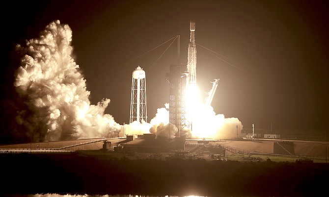 A SpaceX Falcon heavy rocket lifts off from pad 39A at the Kennedy Space Center in Cape Canaveral, Florida, early Tuesday. The Falcon rocket has a payload of military and scientific research satellites. 
(AP Photo/John Raoux)