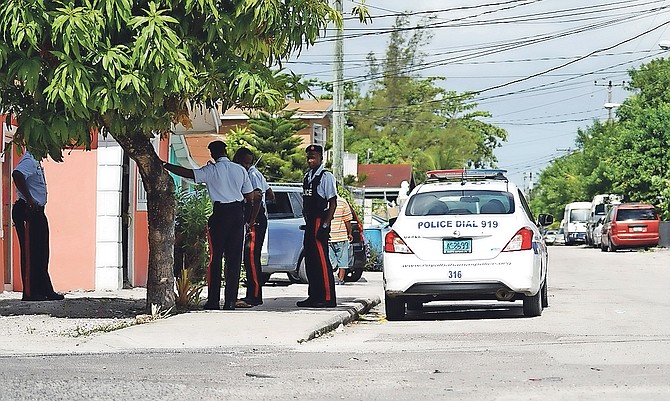 Police conduct door-to-door enquiries in Montel Heights on Sunday. Photo: Terrel W Carey/Tribune staff