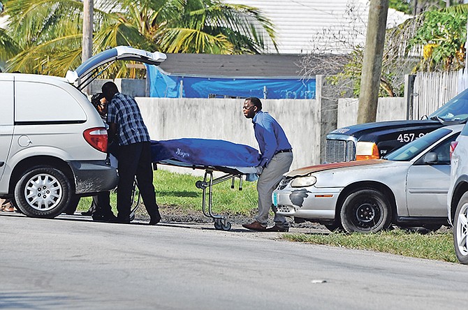The body of the woman is removed from the scene on Wednesday. Photo: Vandyke Hepburn