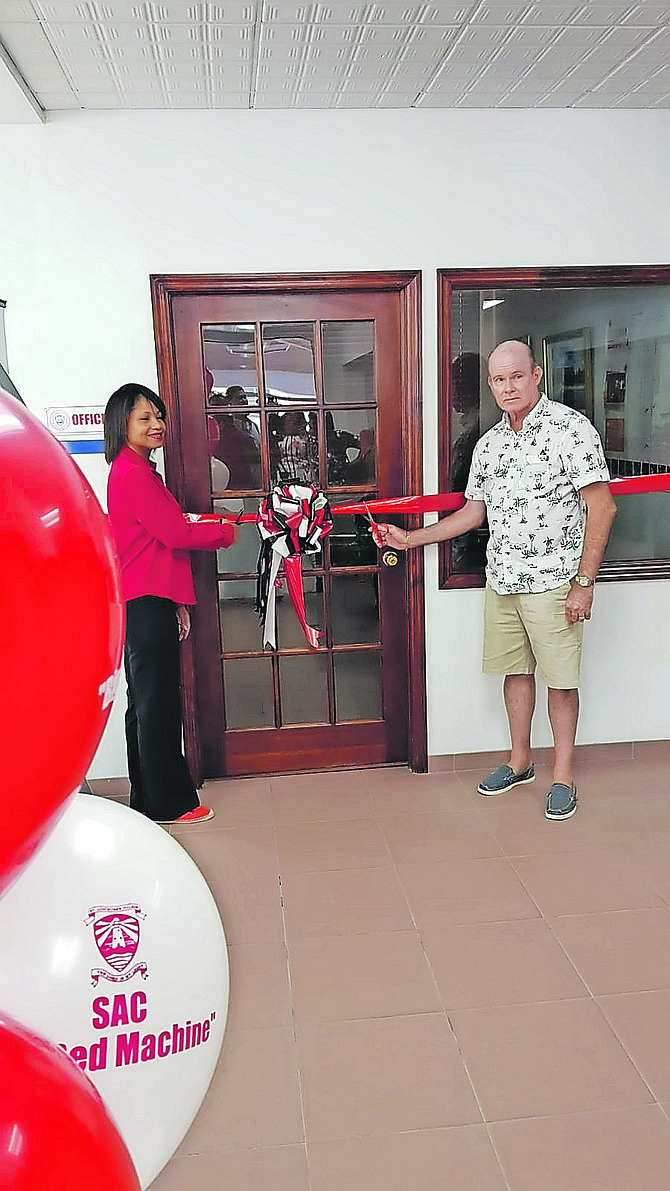 Cherelle Cartwright, SACAA president, and Fred Albury, owner of AutoMall, at the opening of Saint Augustine’s College Alumni Association’s new office.