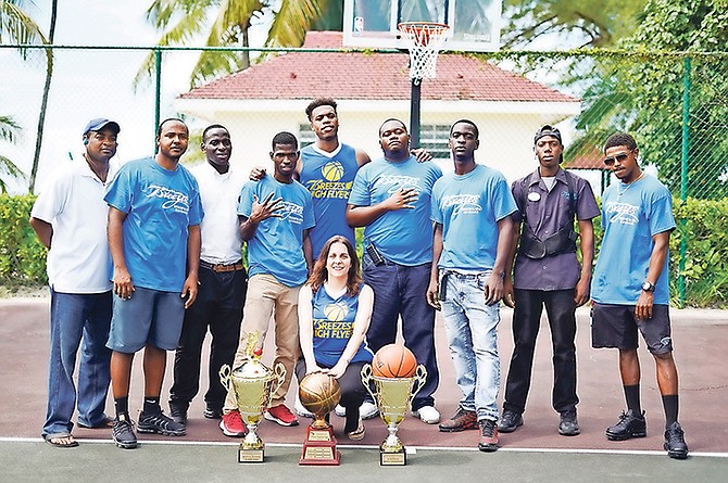 CHAVANO ‘Buddy’ Hield, fifth from left, congratulated coach Donnie Culmer and members of his High Flyers yesterday at SuperClubs Breezes for their three-peat performance as the New Providence Basketball Association champions.

Photo: Terrel W Carey Sr/Tribune Staff