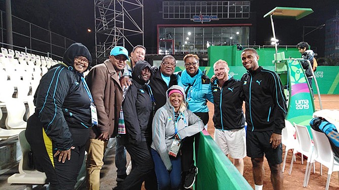 TENNIS players Justin Roberts (far right) and Baker Newman, second from right, share a special moment with other members of Team Bahamas at the Pan American Games in Lima, Peru.