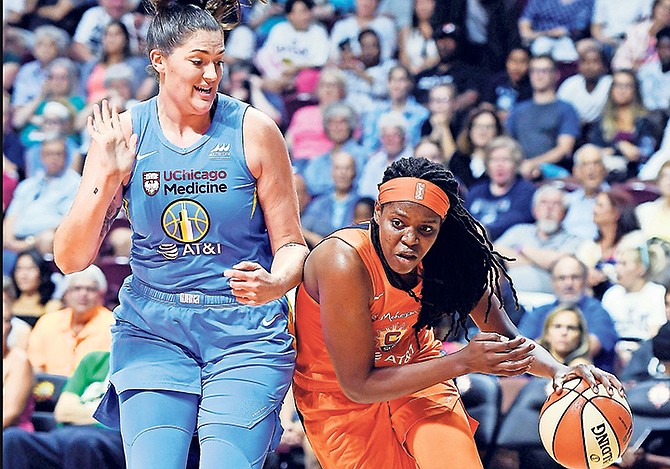 Connecticut Sun centre Jonquel Jones, of the Bahamas, drives around Chicago Sky centre Stefanie Dolson during their WNBAl game on Tuesday night in Uncasville, Connecticut.

(Sean D Elliot/The Day via AP)
