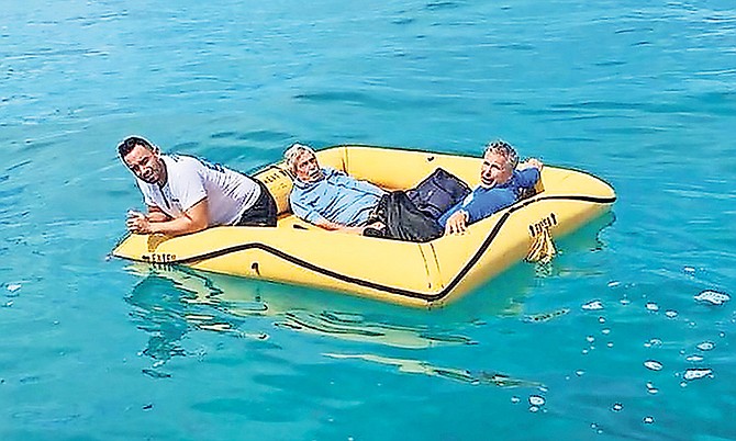 The three Americans who crash-landed near Cat Cay yesterday, afloat in a life raft.