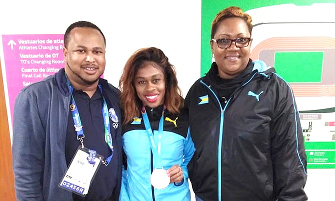 Pan Am women's 200m bronze medalist Tynia Giather is flanked by BOC secretary general Derron Donaldson and track and field manager Dawn Woodside-Johnson in Lima, Peru.