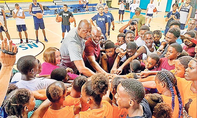 Stephanie Bowers, US chargé d’affaires, former NBA star, coach Patrick Ewing, and Dr Carlos Reid in the huddle with young, aspiring basketball stars.                                                                                                                                                                                                                                                   
                                                                                                                                                                                                                                                    Photos: Complete Sports Management