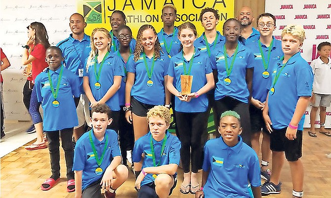 TEAM BAHAMAS members soak up the medal spotlight at the CARIFTA Triathlon and Aquathlon in Kingston, Jamaica. They tied for fifth-place with Aruba.