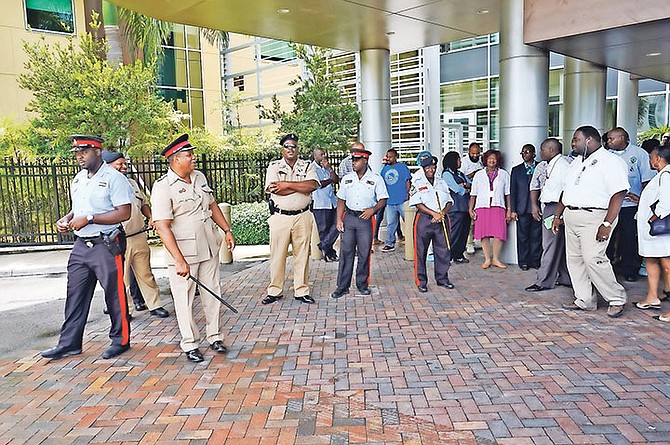 The strike by junior doctors yesterday being monitored by police officers. The Bahamas Doctors Union said more than 400 junior doctors took part in the action.