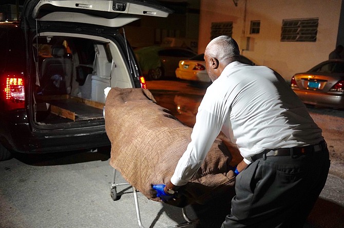 The body is removed from the scene off Cowpen Road on Wednesday night. Photo: Terrel W Carey Sr/Tribune staff