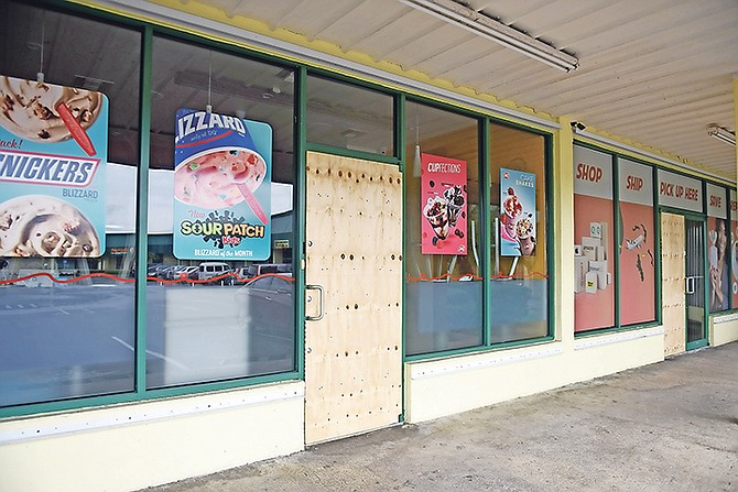 Dairy Queen and Go Postal in the Seagrape Shopping Plaza after looters entered and vandalised their doors. Photo: Shawn Hanna/Tribune Staff