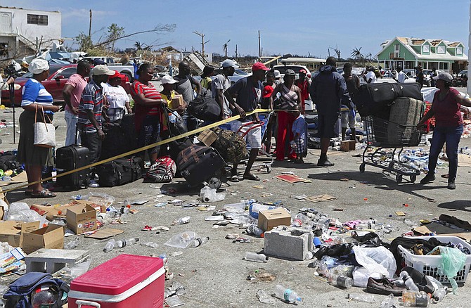 People line up to be evacuated to Nassau in the aftermath of Hurricane Dorian, from the port of Marsh Harbour, Abaco, Sunday. (AP Photo/Fernando Llano)