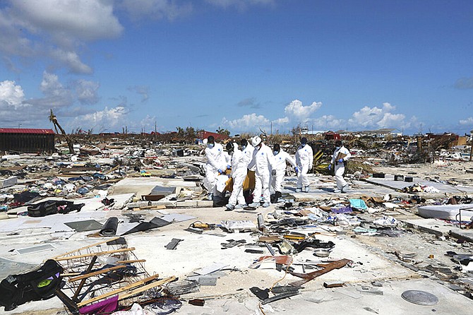 A body is carried out from The Mudd in Abaco on September 9. (AP Photo/Fernando Llano)