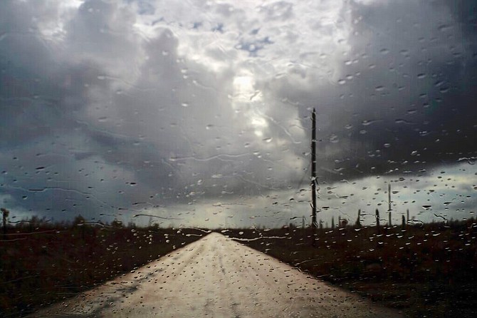 Rain falls on the windshield of a car in McLean's Town, Grand Bahama, Friday. (AP Photo/Ramon Espinosa)