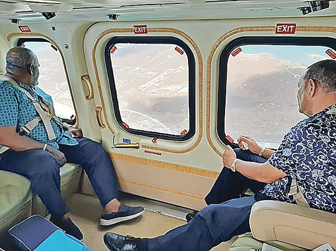 Former Prime Ministers Hubert Ingraham and Perry Christie on a flight to inspect damage in Abaco.