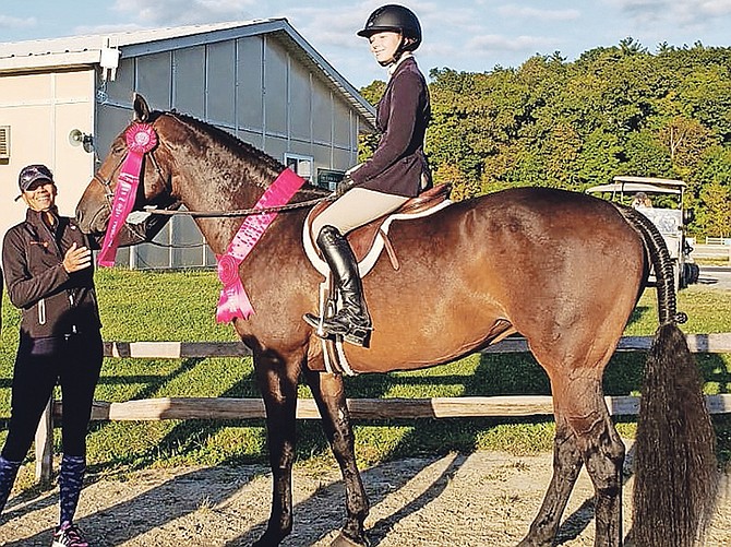 Trainer Erika Adderley-Coello enjoys a smile with Elle O’Brien, who placed 12th out of 76 riders in the Marshall and Sterling 2’ 6” Children’s Medal Final in Saugerties, New York. O’Brien is shown riding My Way, owned by Stacey Vertullo.