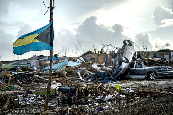 A Bahamas flag flies tied to a sapling, amidst the rubble left by Hurricane Dorian in Abaco in September. (AP Photo/Ramon Espinosa)