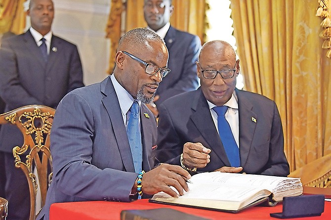 The new Minister of State for Disaster Preparedness, Management and Reconstruction, Iram Lewis, with Governor General Cornelius A Smith during his signing ceremony Monday. Photo: Shawn Hanna/Tribune Staff