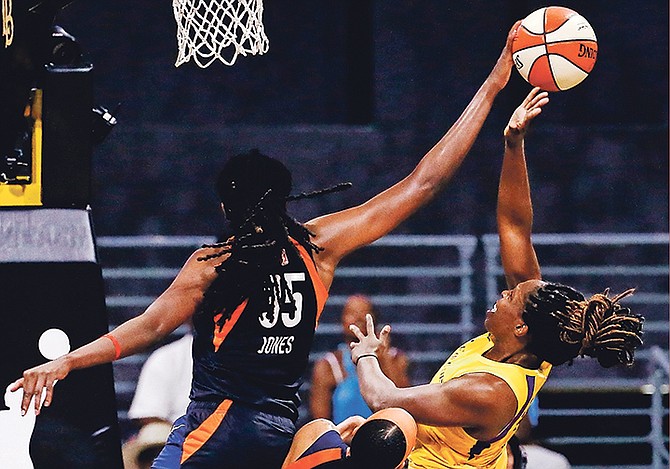 Connecticut Sun’s Jonquel Jones, left, blocks a shot by Los Angeles Sparks’ Chelsea Gray during the first half of Game 3 of their WNBA playoff game last night in Long Beach, California.

(AP Photo/Ringo H.W. Chiu)
