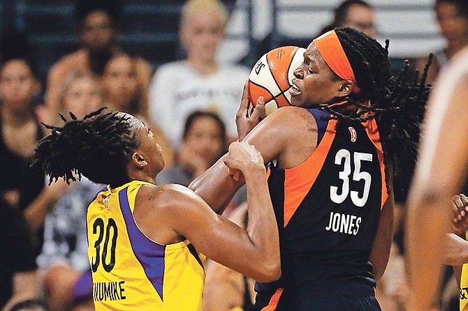 Connecticut Sun’s Jonquel Jones (35) and Los Angeles Sparks’ Nneka Ogwumike (30) fight for a ball during the second half of Game 3. The Sun won 78-56 to advance to the WNBA Finals.