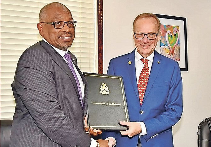 Prime Minister Dr Hubert Minnis, left, with Giora Israel, senior vice president of Carnival Corporation, at the signing of a heads of agreement for a $100m cruise port in the hurricane-hit East Grand Bahama. Another heads of agreement, for an $80m cruise pier at Half Moon Cay, was also signed.