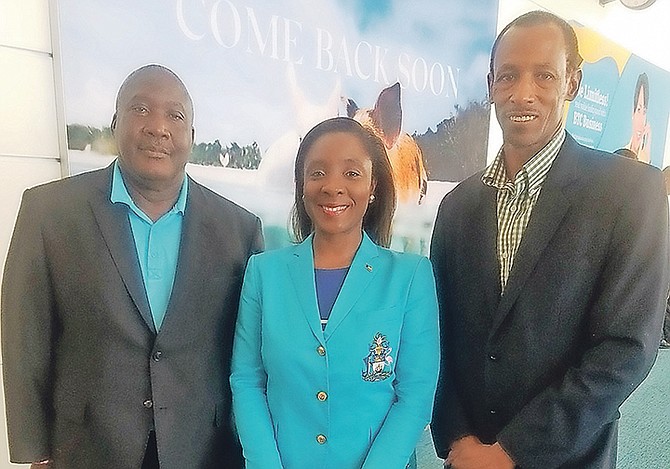 Minister of Youth, Sports and Culture Lanisha Rolle (centre) with national coach Rupert Gardiner and Timothy Munnings, director of sports.
