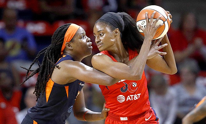 Washington Mystics forward LaToya Sanders, right, protects the ball from Connecticut Sun forward Jonquel Jones in the first half of Game 1 of basketball's WNBA Finals, Sunday. (AP Photo/Patrick Semansky)