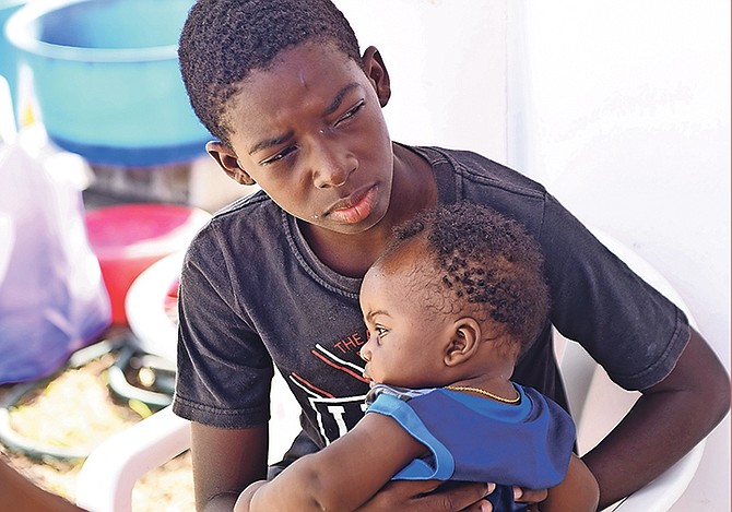 Two youngsters of Haitian descent in Marsh Harbour, Abaco, yesterday. The Tribune canvassed residents to see how they were coping with life after Hurricane Dorian’s passage. 
Photo: Shawn Hanna/Tribune Staff