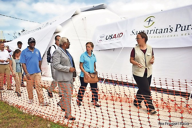 Debbie Wasserman Schultz, centre, being shown around the Samaritan Purse site.