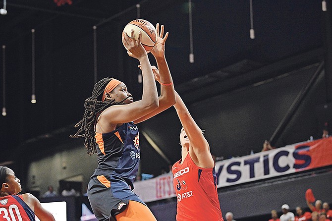 Connecticut Sun forward Jonquel Jones, left, goes to the basket against Washington Mystics forward Elena Delle Donne, right, in the first half of Game 2 of the WNBA Finals last night in Washington.
(AP Photo/Nick Wass)